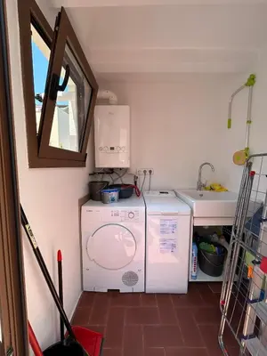 a laundry room with a washer and a sink at CasaBala - Near the beach and Barcelona center in Badalona