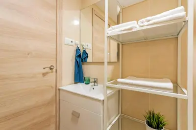 a small bathroom with a sink and a mirror at Apartamento cerca de la playa in Barcelona