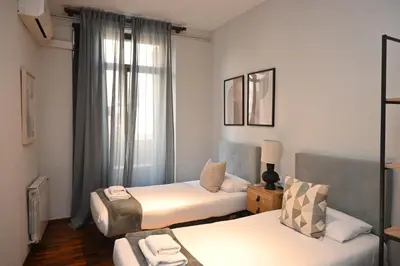a small room with two beds and a couch at Homenfun Barcelona Las Ramblas in Barcelona