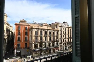 a view of a city from a window at Homenfun Barcelona Las Ramblas in Barcelona