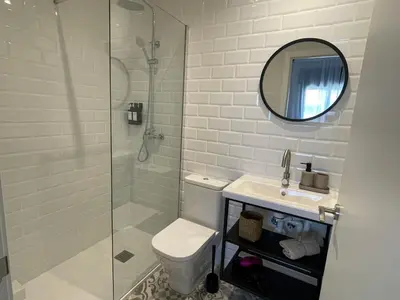 a bathroom with a shower and a toilet and a sink at Barcelona PR Guesthouse in El Prat de Llobregat