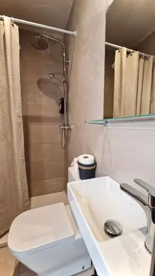 a bathroom with a sink and a toilet and a shower at Barcelona PR Guesthouse in El Prat de Llobregat