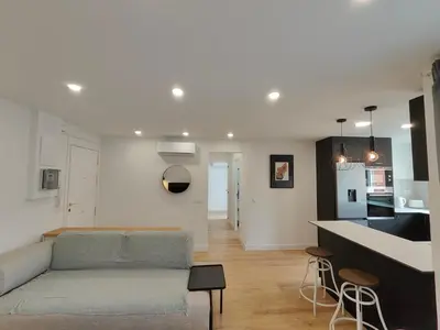 a living room with a couch and a kitchen at Fantastic apartment Sant Adria Beach in Sant Adria de Besos