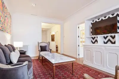 a room with three beds and a mirror on the wall at The Collection Barcelona - Casa Batlló - Luxury Historic 4BD 4BTH for 9 guests in Barcelona
