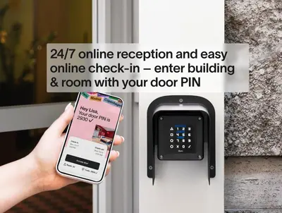 a person holding a cell phone in front of a door at Numa Barcelona Colmena in Barcelona