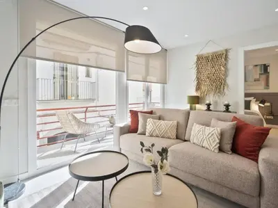 a living room with a couch and a table at Sitges Spaces Deluxe Comfort Flat-Monthly Rentals in Sitges