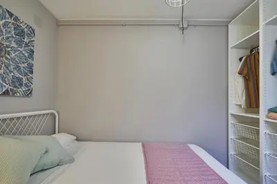 a small bedroom with a bed and a closet at BeBarceloner Sant Andreu Apartments - 1 bedroom in Barcelona