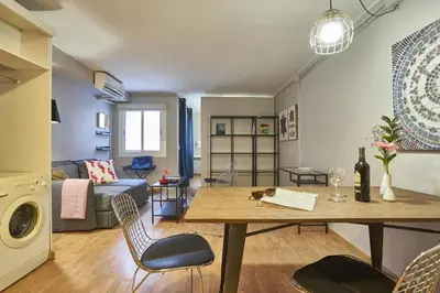 a living room with a table and chairs in a room at BeBarceloner Sant Andreu Apartments - 1 bedroom in Barcelona