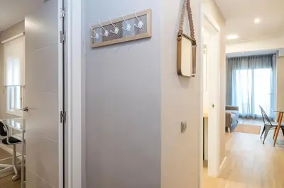 a hallway with a door leading to a living room at BeBarceloner Sant Andreu Apartments - 3 bedrooms with terrace in Barcelona