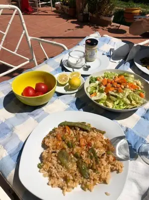 a table with plates of food and a salad at Cottage Eco-Friendly Barcelona country side in La Garriga