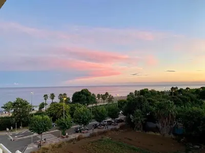 a parking lot with parked cars and the ocean at Apart. Pineda de Mar-Sea and mountains views in Pineda de Mar