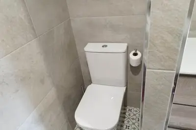 a bathroom with a toilet and a roll of toilet paper at HHBCN Beach Apartment Castelldefels #3 in Castelldefels