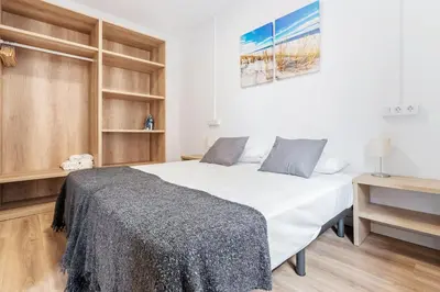 a bedroom with a large white bed and wooden shelves at AB Nou de la Rambla in Barcelona