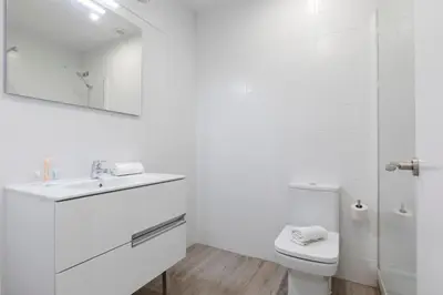 a white bathroom with a sink and a toilet at AB Comte d'Urgell - 2975 in Barcelona