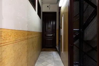 a hallway with a red door and a staircase at AB Comte d'Urgell - 2975 in Barcelona