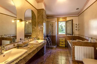 a large bathroom with two sinks and a shower at Catalunya Casas Spacious, Sublime Villa just 15km to Barcelona! in Torrelles de Llobregat