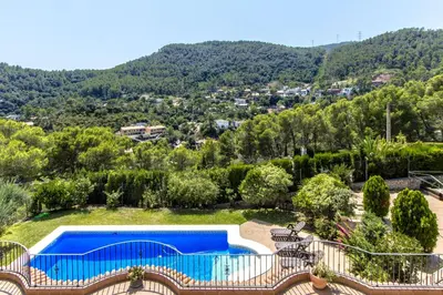 a swimming pool in a yard with a mountain at Catalunya Casas Spacious, Sublime Villa just 15km to Barcelona! in Torrelles de Llobregat