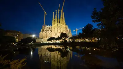 a building with a reflection in the water at night at Catalunya Casas Spacious, Sublime Villa just 15km to Barcelona! in Torrelles de Llobregat