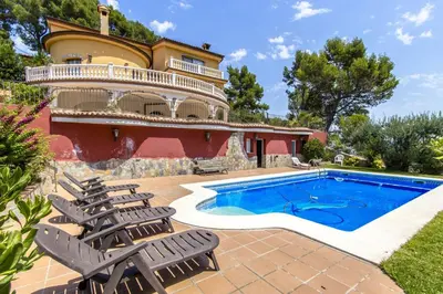 a villa with a swimming pool and chairs at Catalunya Casas Spacious, Sublime Villa just 15km to Barcelona! in Torrelles de Llobregat