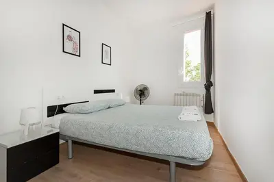 a white bedroom with a bed and a window at The Collection Barcelona - Comfortable 3BD in Poblenou next to the beach only for Families! in Barcelona
