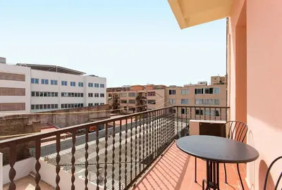 a balcony with a table and a view of a city at The Collection Barcelona - 3BD only for Families in Poblenou next to the beach! in Barcelona