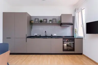 a kitchen with white cabinets and a sink and a window at The Collection Barcelona - 3BD only for Families in Poblenou next to the beach! in Barcelona