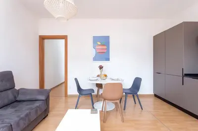 a living room with a couch and a table and chairs at The Collection Barcelona - 3BD only for Families in Poblenou next to the beach! in Barcelona