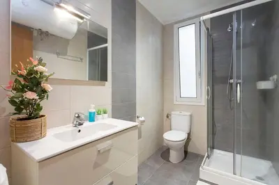 a bathroom with a toilet and a sink and a shower at The Collection Barcelona - Sunny 3BD only for Families in Poblenou next to the sea! in Barcelona