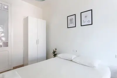a white bedroom with a white bed and a window at The Collection Barcelona - Poblenou only for Families 3BD next to the beach! in Barcelona