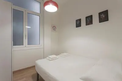 a white room with a bed and a window at The Collection Barcelona - Poblenou only for Families 3BD next to the beach! in Barcelona