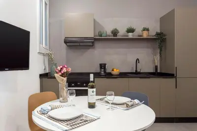 a kitchen with a table with a bottle of wine at The Collection Barcelona - Poblenou only for Families 3BD next to the beach! in Barcelona