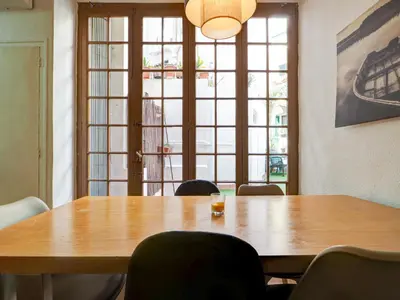 a conference room with a wooden table and chairs at Charming Patio by Hello Homes Sitges in Sitges