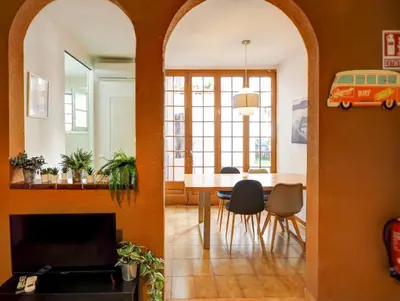a living room with a table and a dining room at Charming Patio by Hello Homes Sitges in Sitges