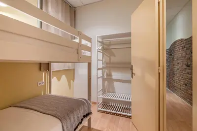 a small bedroom with a bunk bed and a closet at Stay U-nique Apartment Maurici Serrahima in Barcelona