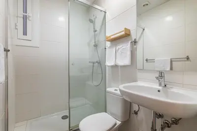 a bathroom with a toilet and a sink and a shower at Stay U-nique Apartment Maurici Serrahima in Barcelona