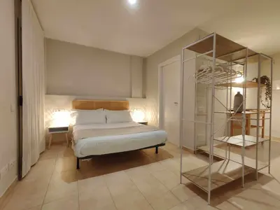 a bedroom with a bed and a glass shelf at Mazi Apartments Havana in Mataró