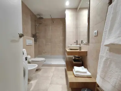 a bathroom with a toilet and a sink and a shower at Mazi Apartments Havana in Mataró