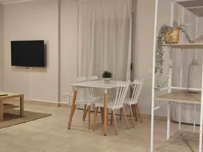 a dining room with a white table and chairs at Mazi Apartments Havana in Mataró