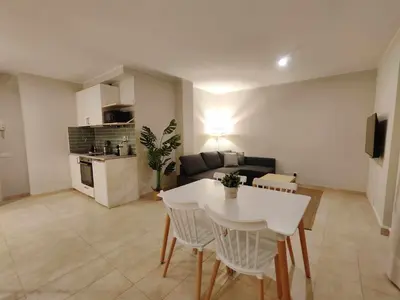 a living room with a white table and a couch at Mazi Apartments Havana in Mataró
