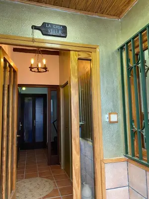 a entrance to a house with a sign above the door at La Casa Vella EL BEDORC in Piera