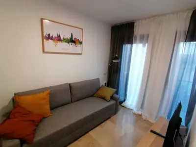 a living room with a couch and some windows at Piso pl 2A, 20 min Plaza Cataluña in Sant Adria de Besos
