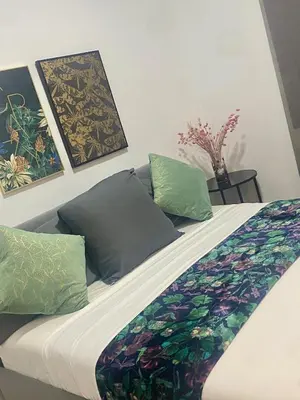 a bed with two pillows on top of it at Barcelona Chic Apartments- Free Parking - 10 min BCN center by metro in Barcelona