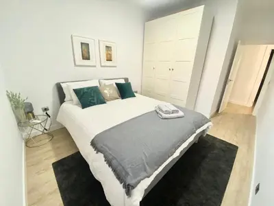 a bedroom with a large white bed with pillows at Barcelona Chic Apartments- Free Parking - 10 min BCN center by metro in Barcelona
