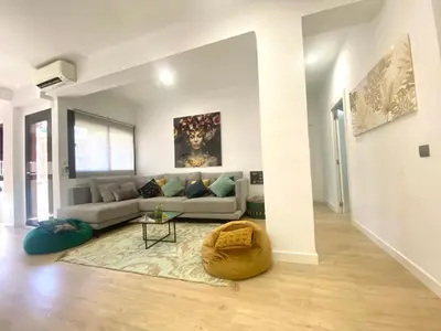 a white living room with a couch and a table at Barcelona Chic Apartments- Free Parking - 10 min BCN center by metro in Barcelona
