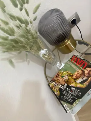 a table with a magazine and a lamp and a magazine at Barcelona Chic Apartments- Free Parking - 10 min BCN center by metro in Barcelona