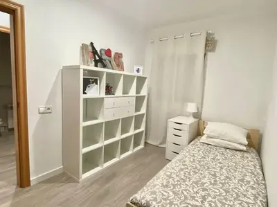 a bedroom with a bed and a white dresser at Nice new apartment only 30min to Barcelona center. in Granollers
