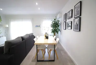 a living room with a table and a couch at Nice new apartment only 30min to Barcelona center. in Granollers