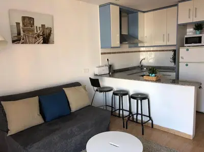 a living room with a couch and a kitchen at Nice 2 rooms apartment in the heart of barcelona in Barcelona