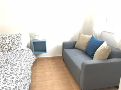 a living room with a couch and a bed at Nice 2 rooms apartment in the heart of barcelona in Barcelona