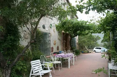 a table and chairs sitting outside of a building at MASIA CAN SUNYER AGROTURISMO in La Garriga